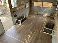 the inside of a mobile home with wood flooring