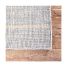 a rug on the floor that is made out of wood and has two different colors