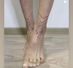 a woman's feet with tattoos on them