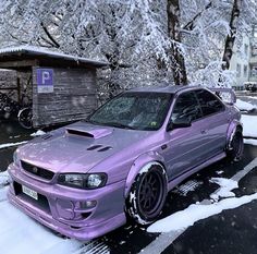 a purple car is parked in the snow