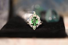 Gorgeous LARGE Green Tsavorite Garnets set in a stunning art deco style setting. This ring has all that glam and drama with the vibrant greens glowing off the high polished silver. There are two small Tsavorite Garnets that sit top and bottom of this ring. If you love rings with drama and color then this is definitely for you, the emerald greens from the natural Tsavorite will spark inspiration and pure joy. Its an all around BOMBSHELL of a ring.This ring is set in a size 8.Tsavorite Garnet: Cla Art Deco Emerald Ring As Gift, Art Deco Emerald Ring For Gift, Art Deco Emerald Ring Gift, Green Sterling Silver Art Deco Jewelry, Heirloom Style Green Emerald Ring With Polished Finish, Heirloom Style Polished Emerald Ring, Art Deco Green Jewelry With Accent Stones, Art Deco Green Jewelry For Anniversary, Green Art Deco Jewelry With Accent Stones