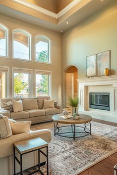 a living room with couches, chairs and a fire place in the center area