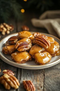 some pecans are on a plate with caramel sauce