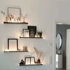 some shelves with pictures and candles on them