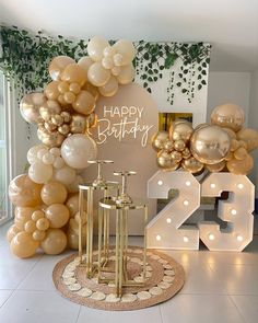 balloons and candles are on display in front of a happy birthday sign with the number twenty five