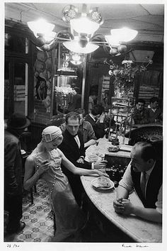 a group of people sitting around a table in a restaurant