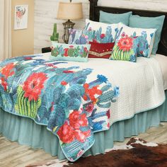 the bed is made with cactus and flowers on it