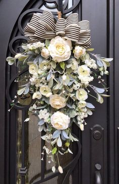 a bouquet of flowers is hanging on the front door