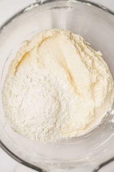 a bowl filled with flour on top of a table