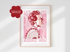 a pink poster with the words let me adore you on it and a woman's face