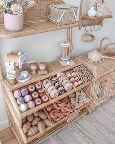 a shelf filled with lots of different types of donuts on top of wooden shelves