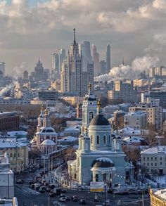 the city skyline is covered in snow and clouds