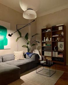 a living room filled with furniture and a painting on the wall