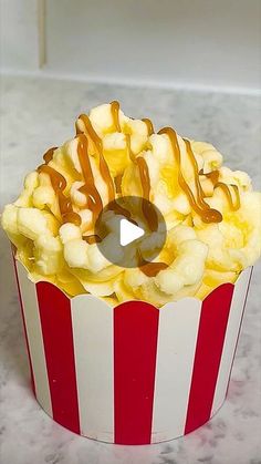 a red and white striped cup filled with popcorn