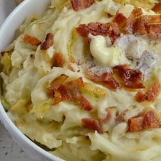 a white bowl filled with mashed potatoes and bacon