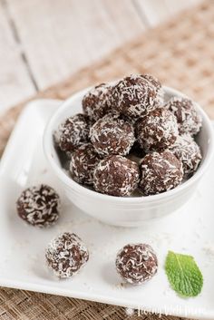 chocolate mint balls in a white bowl on a plate with mint leaves and text overlay