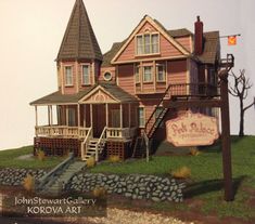 a model of a house on display in front of a sign