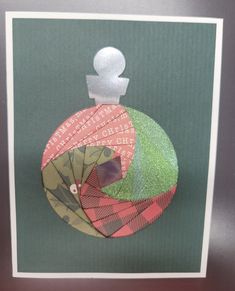 a card with an ornament made out of different types of fabric and paper