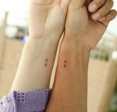 two people with matching tattoos on their arms