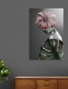 a woman with pink flowers in her hair on a gray wall next to a dresser