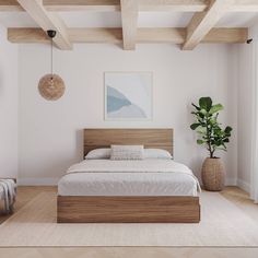 a bed sitting in a bedroom next to a wooden table with a potted plant on top of it