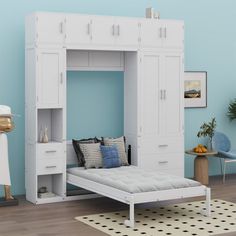 a white bed sitting under a blue wall in a bedroom