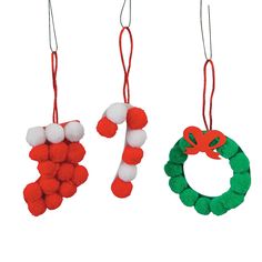 three christmas ornaments hanging from strings with pom - poms on the top and bottom