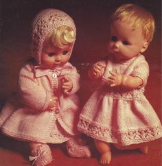 two baby dolls are dressed in pink outfits