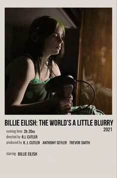 a woman sitting in front of a window with headphones on and text reading billie elish the world's a little blurry