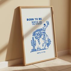 a framed poster on the floor with a cowboy riding a horse and text born to be wild