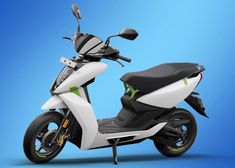 a white and green scooter on a blue background