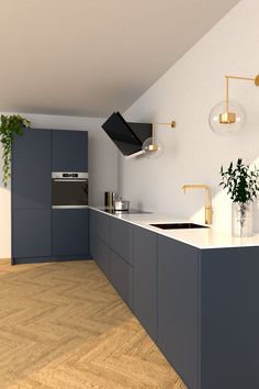 a modern kitchen with blue cabinets and white counter tops, gold faucets and potted plants