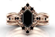 an intricately designed black diamond engagement ring set in rose gold with diamonds on each side