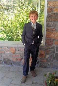 a young man wearing a suit and tie