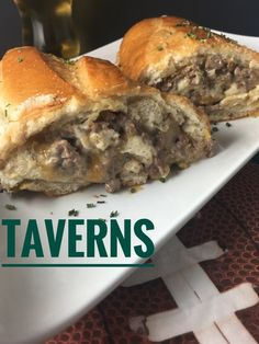 there is a sandwich with meat on it and the words tavern's in front of it