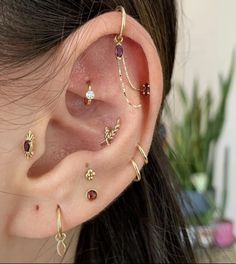 an ear with several different types of piercings on it