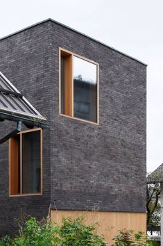 a brick building with two windows on the side