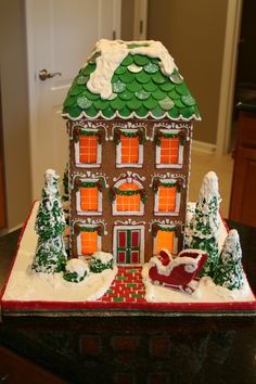 a gingerbread house is decorated with icing and christmas decorations for the holiday season