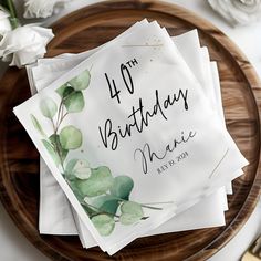 four napkins with the number fortyth birthday on them sitting on a wooden plate