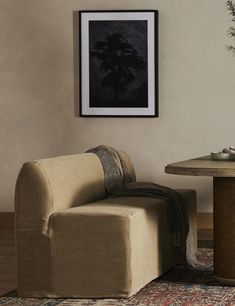 a chair and table in a room with a rug on the floor next to it