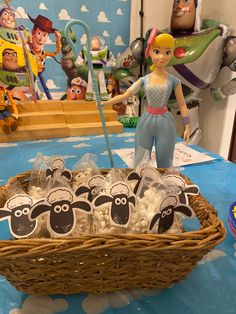 a basket filled with marshmallows sitting on top of a blue table cloth