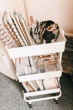 a white cart filled with lots of office supplies