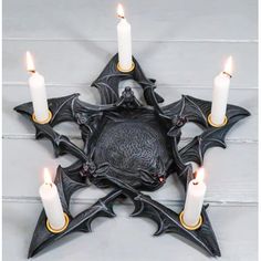 a star shaped candle holder with five candles in it and an ornate design on the front