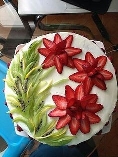 a cake decorated with strawberries and leaves