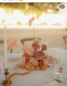 the table is set with flowers and candles