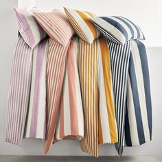 four striped pillows stacked on top of each other