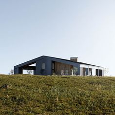 a house on top of a grassy hill