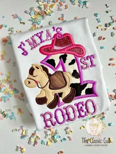 * A sweet first birthday top for girls.   * The design is sewn with 1 in cow print fabric, with a horse and pink cowboy hat with purple personalization * this listing includes the bodysuit or shirt only.  color changes are welcome Cowgirl Theme Birthday, Purple Cowgirl, Sweet First Birthday, Cow Print Fabric, Pink Cowboy Hat, My First Rodeo, Pink Cowboy, First Rodeo, Chapeau Cowboy