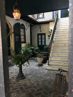 an open door leading to a courtyard with stairs