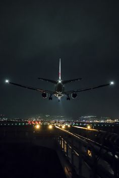 an airplane taking off from the runway at night